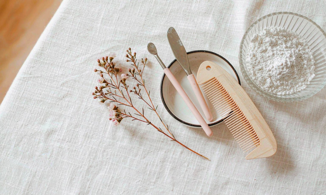 Overhead flat lay of neutral nail care tools, comb and fine white powder