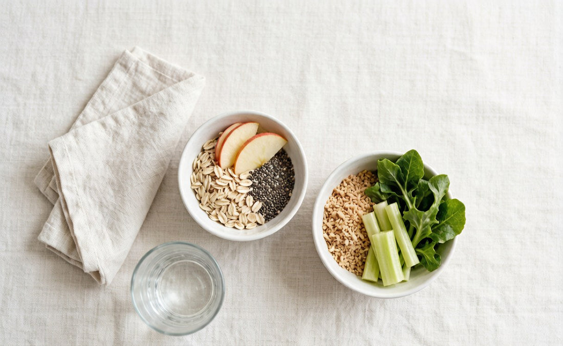Overhead flat lay of oats, chia and apple beside bran, greens and celery on pale linen