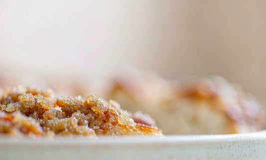 Macro close-up of golden caramelized sugar crystals and toasted crust texture