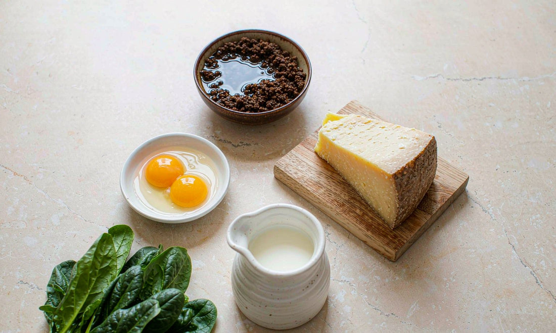 Flat lay of fermented soybeans, aged cheese, egg yolks, spinach and milk on pale stone
